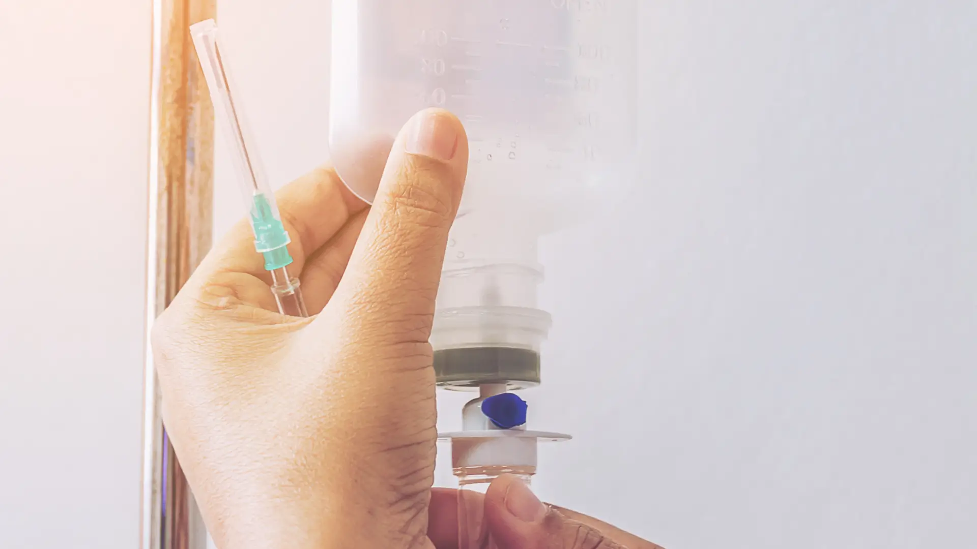 A nurse removing the completed NAD+ IV infusion drip.