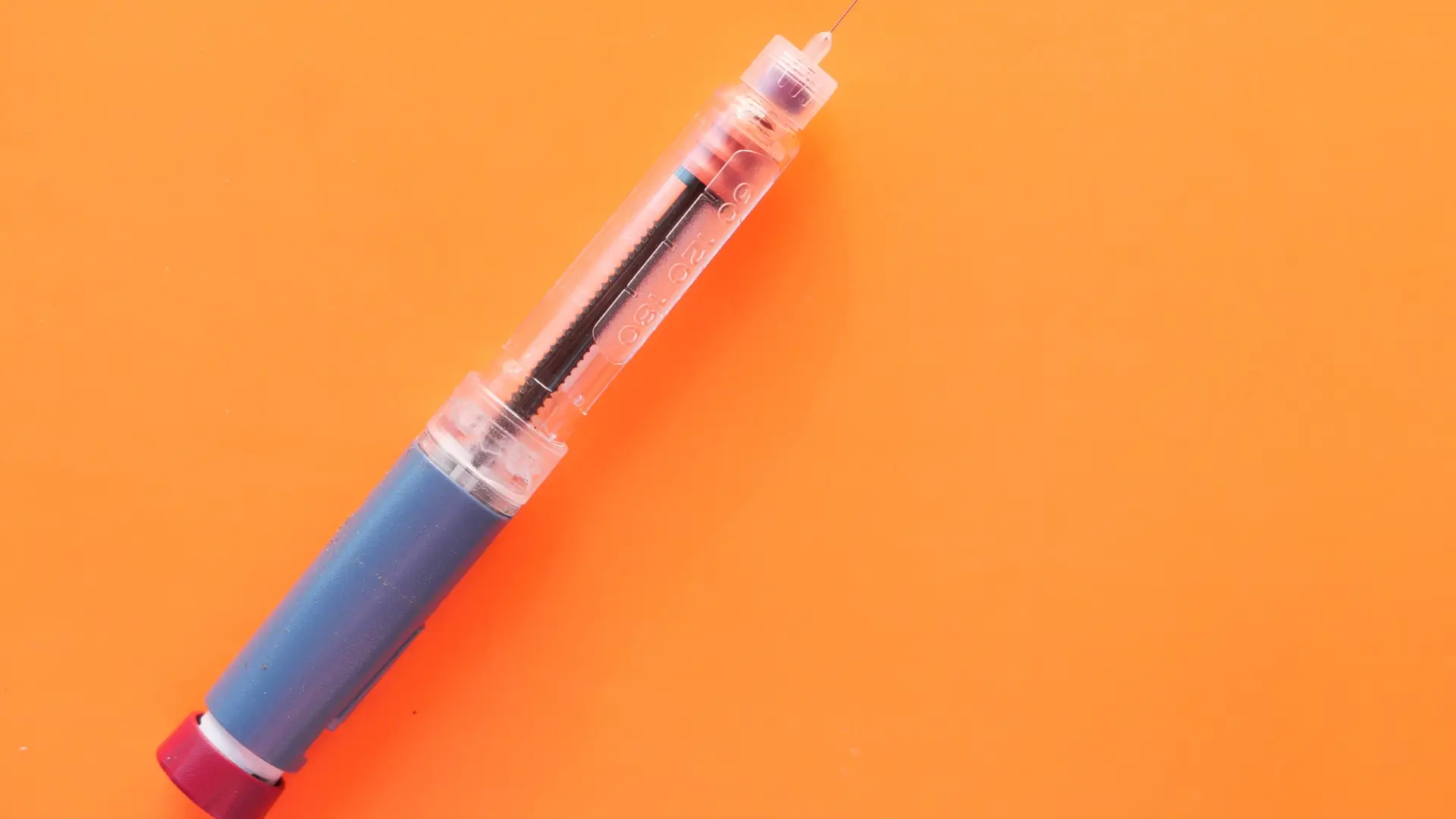 A close-up shot of a single-dose injection pen, like the Mounjaro pen.
