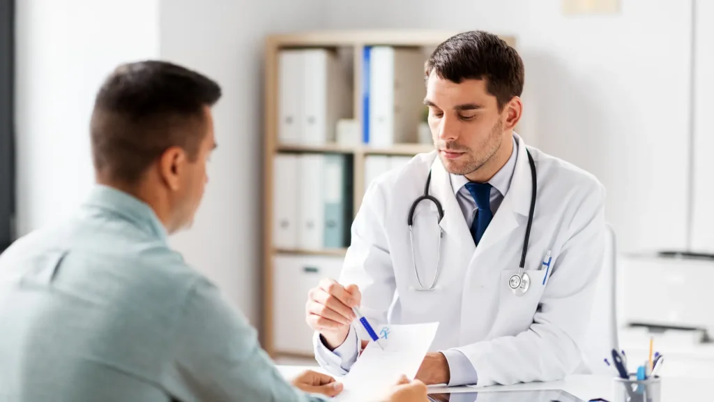 A doctor explaining the prescription to a male patient.