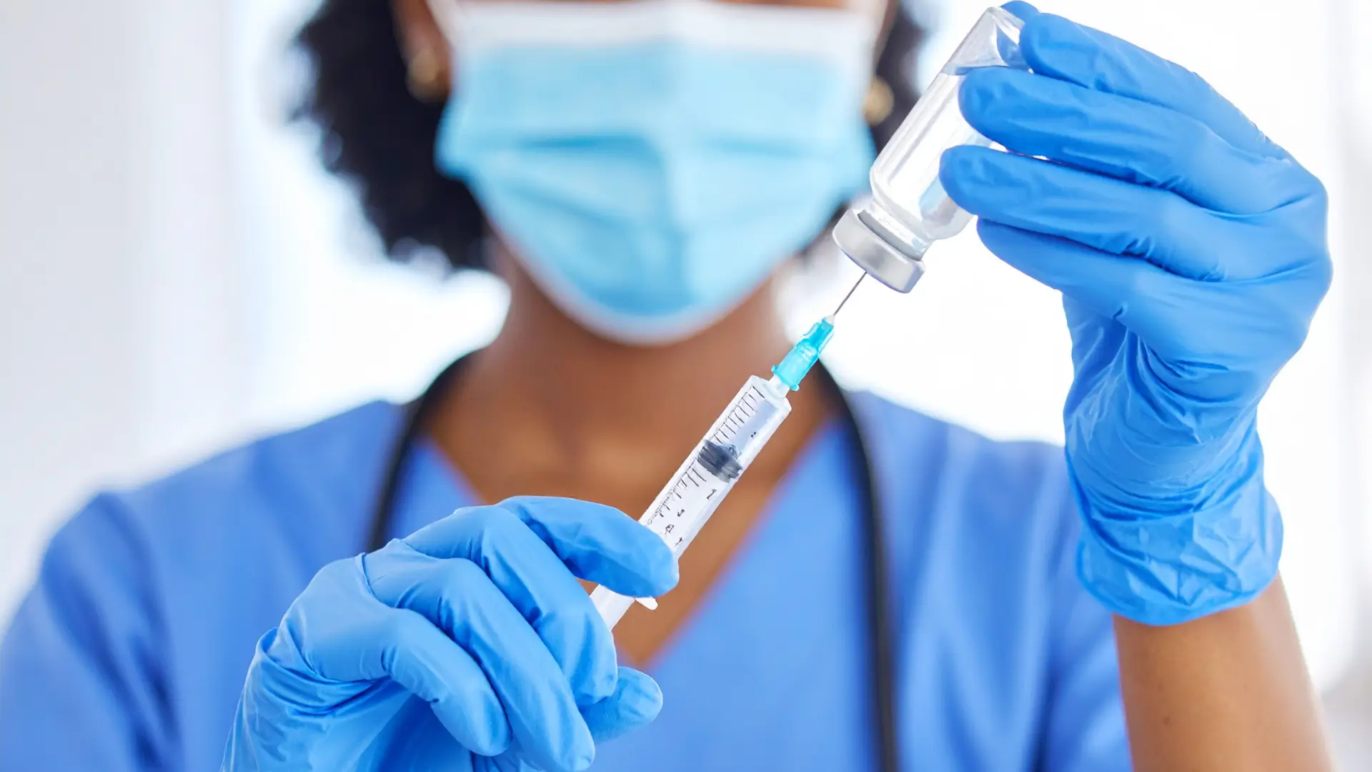 A medical provider preparing for an injection session, like a Xolair therapy.