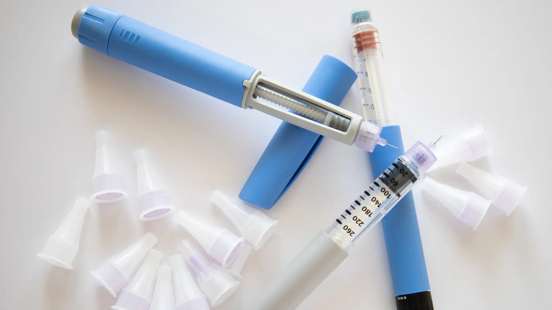 Prefilled self-administered pen injections, like Ozempic and Wegovy, on a surface.