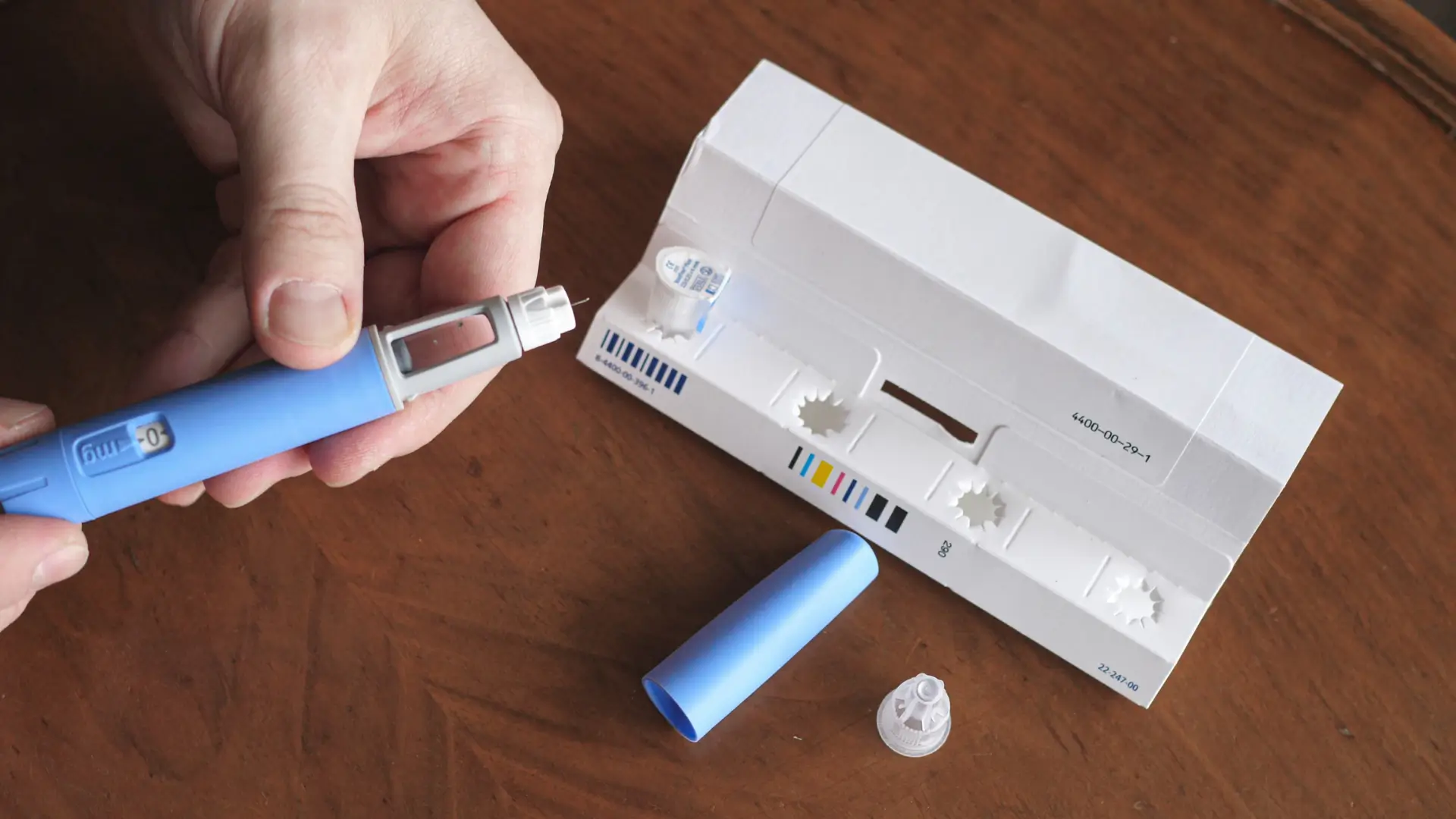 An individual preparing an Ozempic injection for their administration.