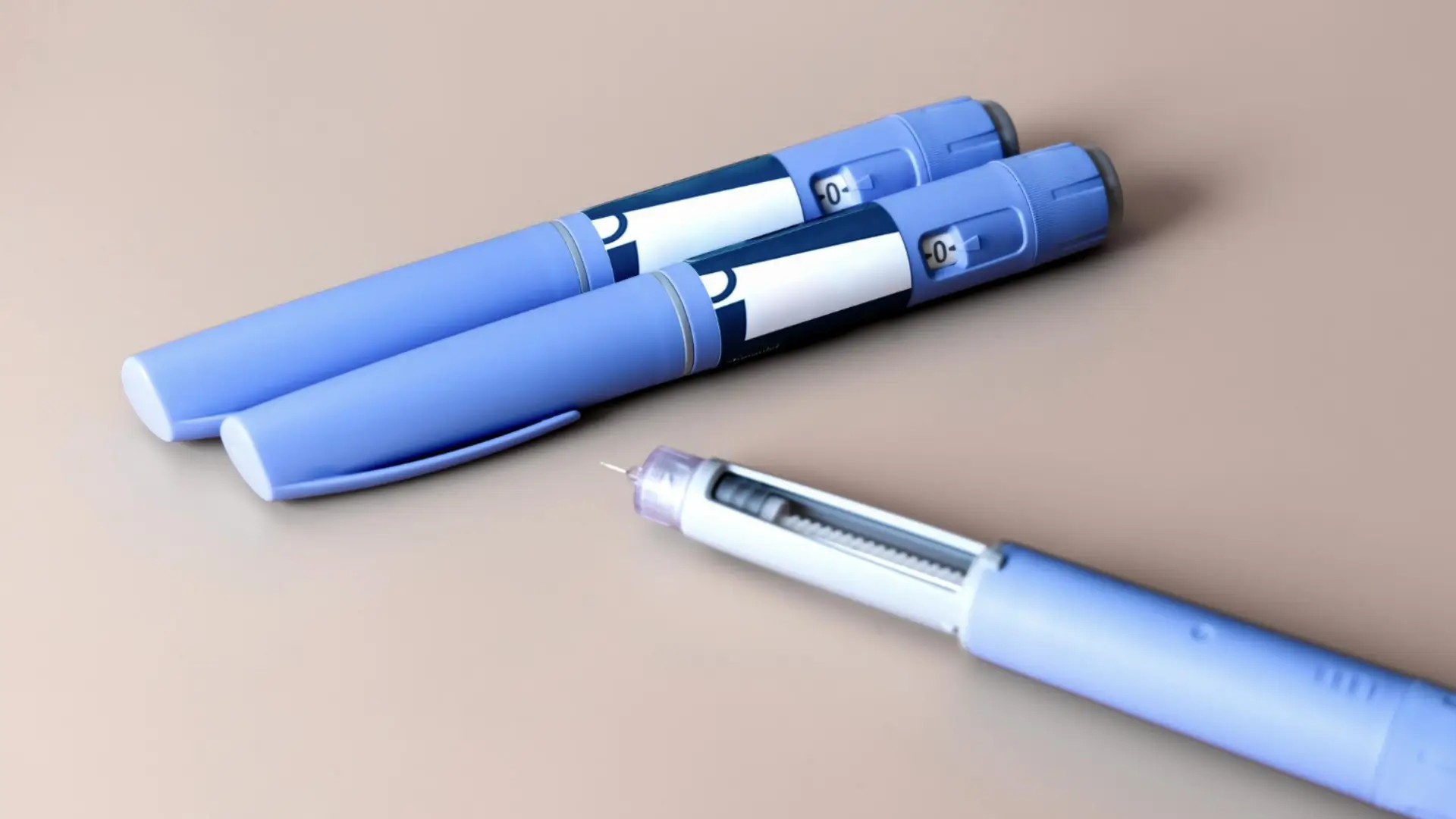 Three Ozempic injections placed on a surface.