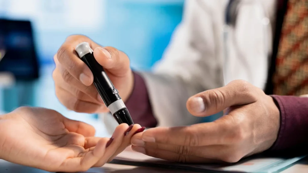 A medical professional checking a patient's blood sugar via glucometer test.