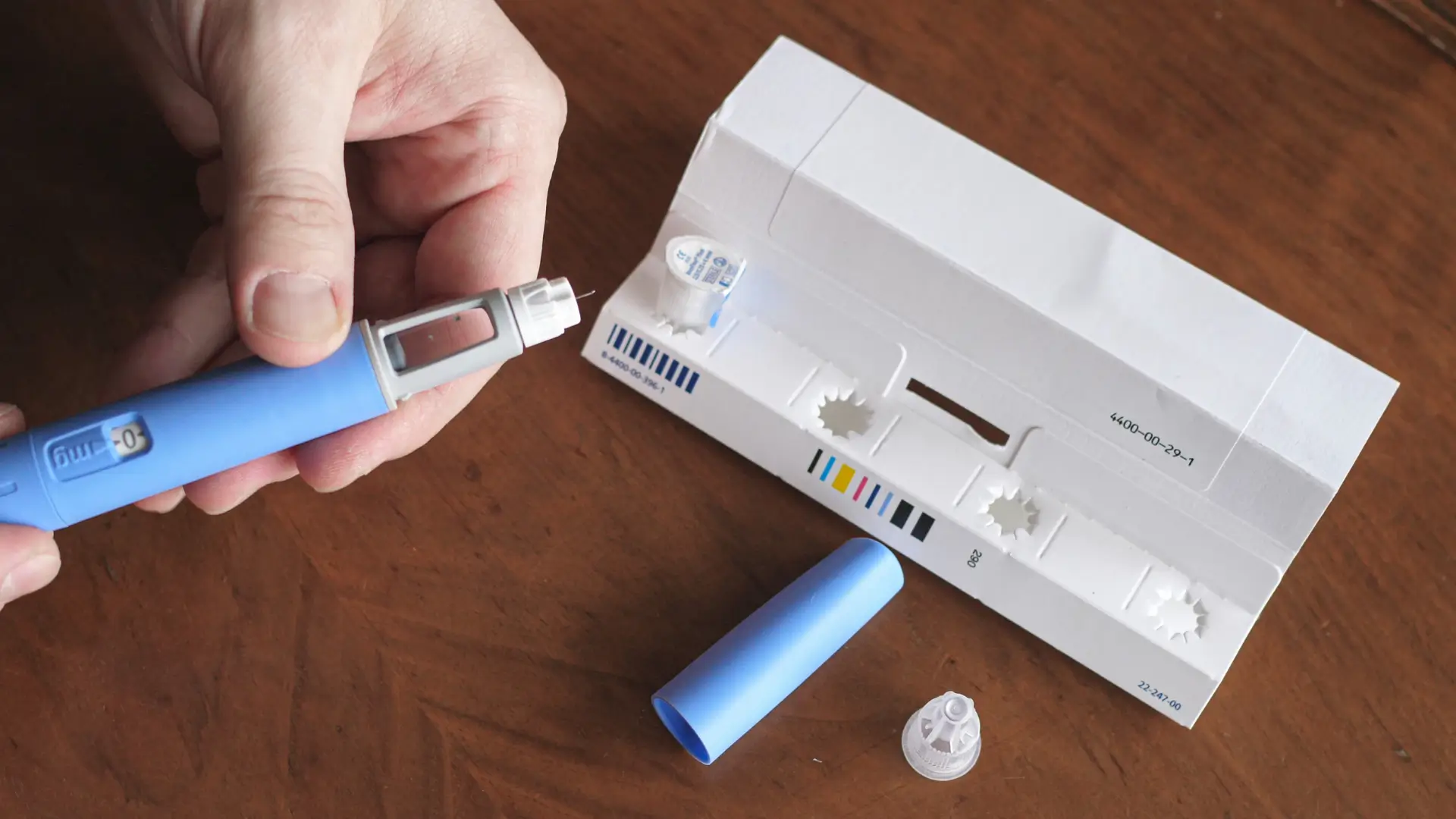 A patient preparing their Ozempic pen injection before administration.