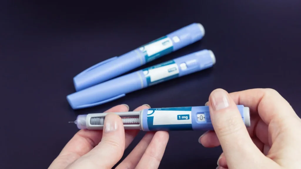 An individual preparing the Ozempic 1 mg pen dosage before administration.