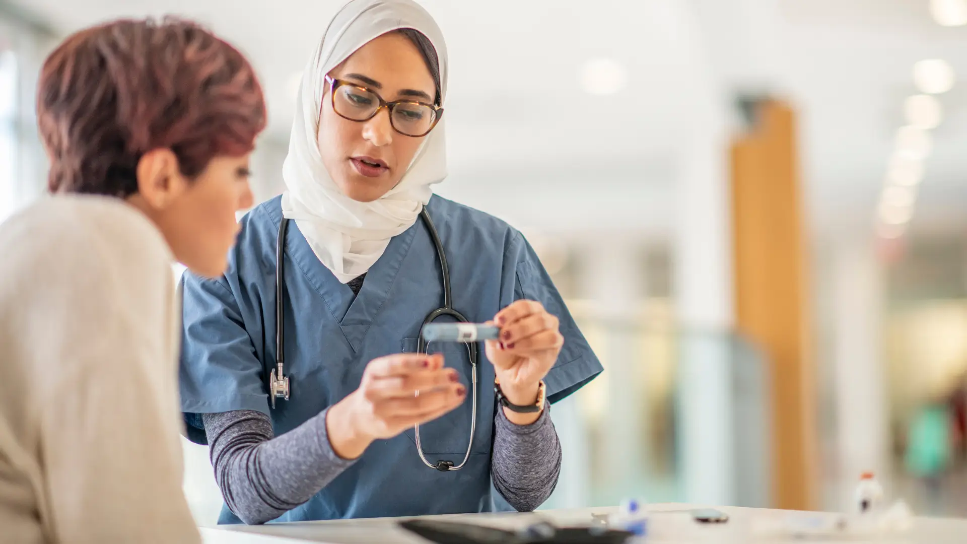 A female doctor explaining how to take Ozempic to a diabetic patient.