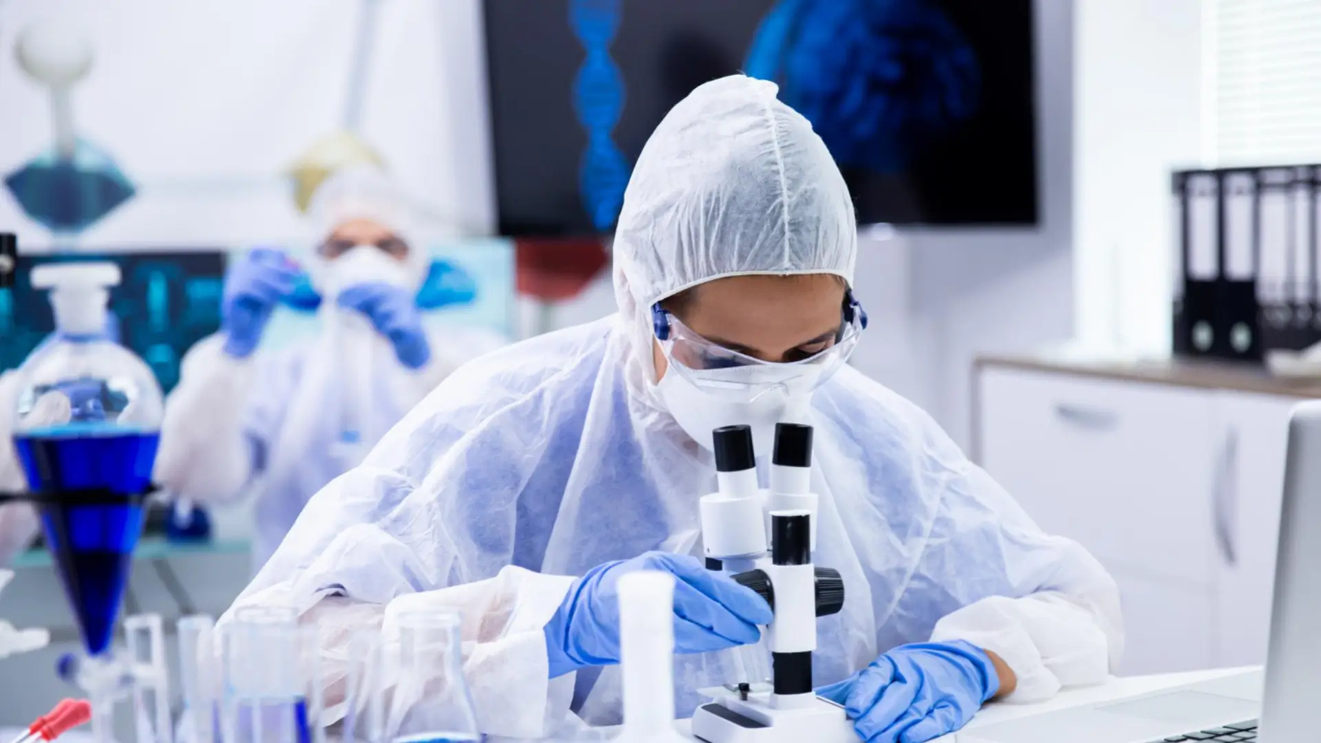 A researcher showing Ipamorelin benefits across growth hormone stimulation, body composition, recovery, sleep, and peptide comparisons in experimental studies.