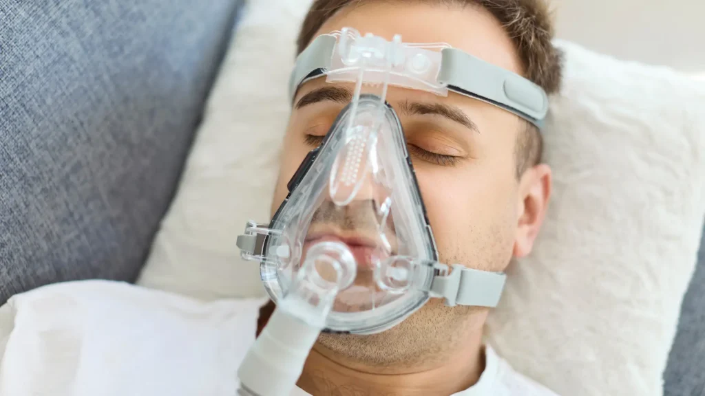 A male patient using CPAP to address obstructive sleep apnea, which retatrutide has a potential benefit for when used appropriately and studied more.
